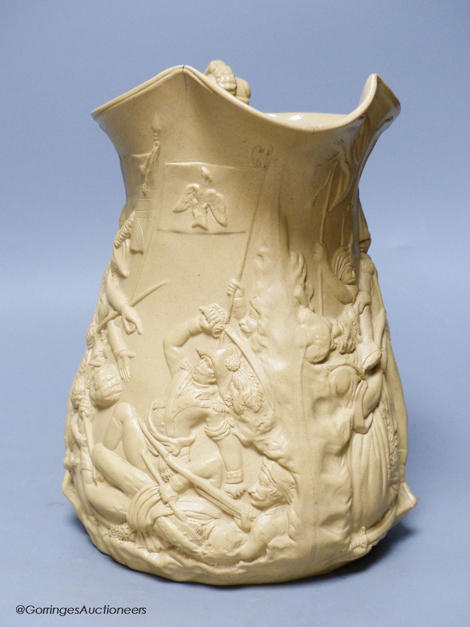 A Victorian relief moulded buff coloured stoneware jug by Samuel Alcock, The Seige of Acre, circa 1850.